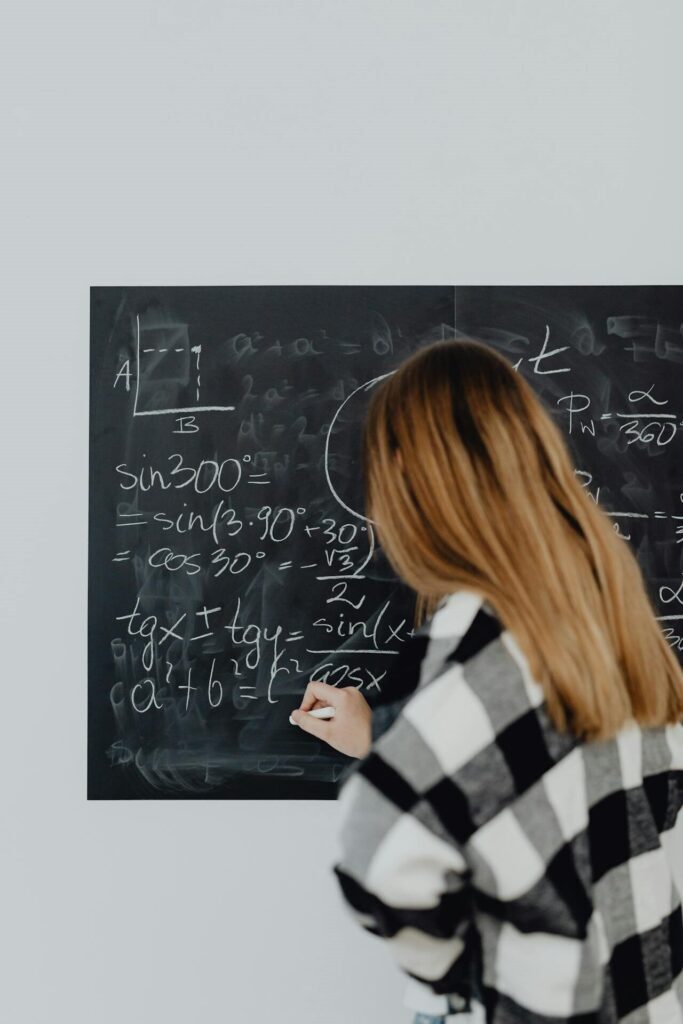 Teenage Girl Solving a Maths Task on the Blackboard learning algorithm