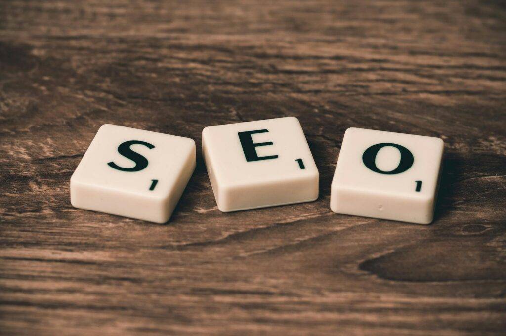 three white and black scrabble tiles on brown wooden surface SEO