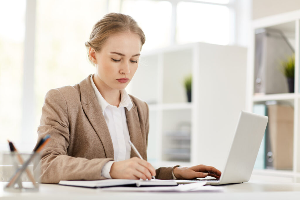 Bookkeeper and woman looking over accounting papers
