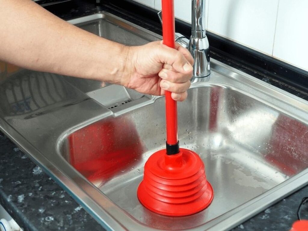 plumber unblocking drain